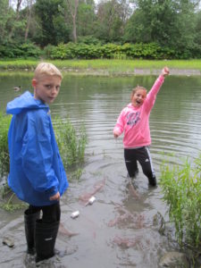 Students in river with net