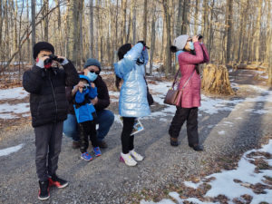 family viewing birds with binoculars