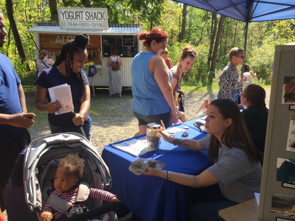 Fall festival - family looking at snake skin